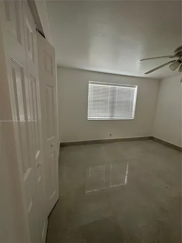 an empty room with a empty space and windows