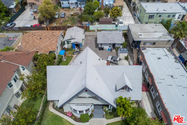 an aerial view of multiple houses with a yard