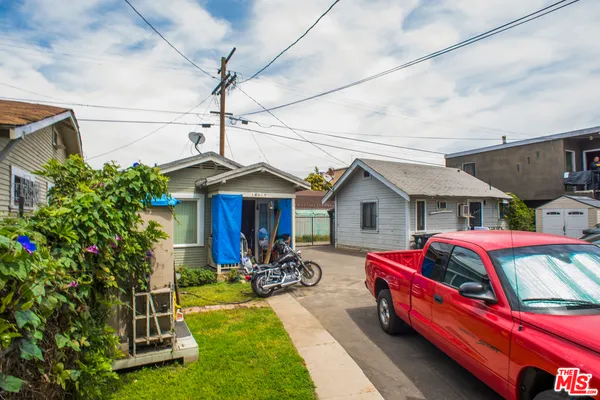 a front view of house with outdoor space and car parked