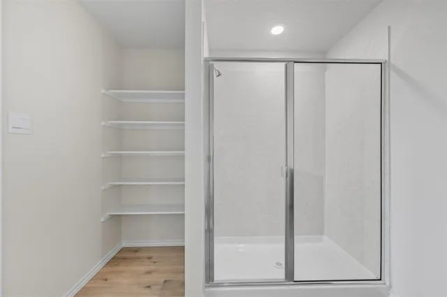 a view of walk in closet with empty racks