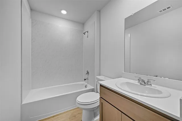a bathroom with a sink toilet vanity and shower