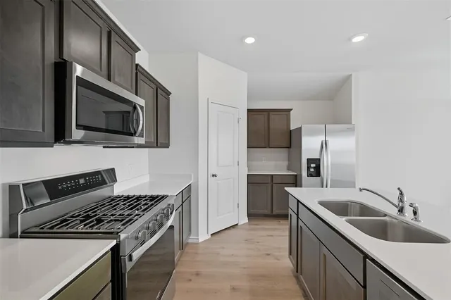 a kitchen that has a sink and a stove top oven
