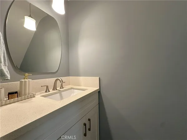 a bathroom with a sink vanity and a mirror