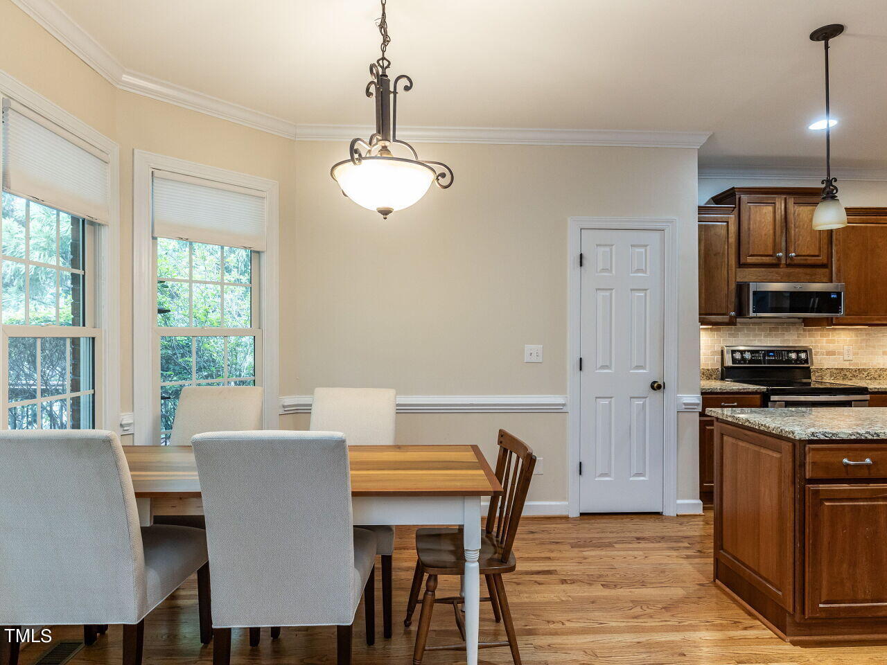 119 Oldefield Lane Garner, NC 27529 - Photo 11 of 38 a view of a dining room with furniture window and wooden floor