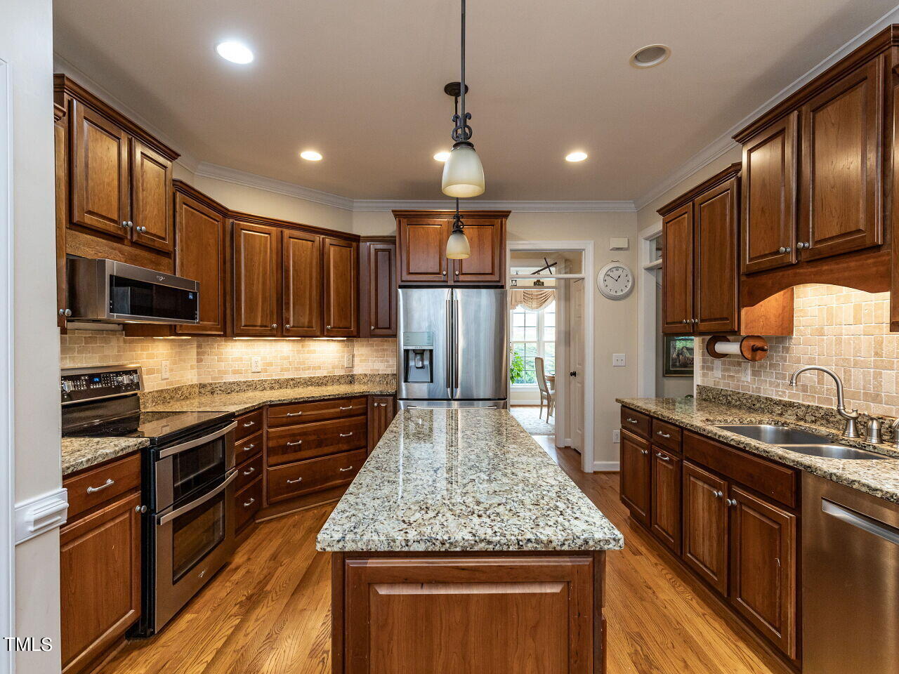 119 Oldefield Lane Garner, NC 27529 - Photo 13 of 38 a kitchen with stainless steel appliances granite countertop granite counter tops refrigerator a stove top oven and large cabinets
