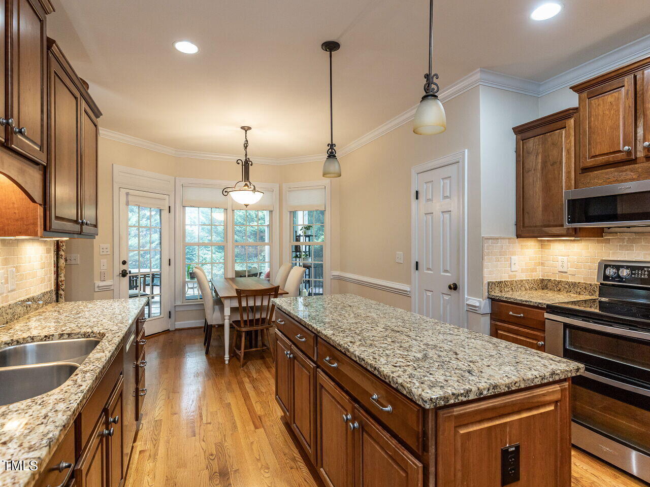 119 Oldefield Lane Garner, NC 27529 - Photo 14 of 38 a kitchen with stainless steel appliances granite countertop a sink stove and refrigerator