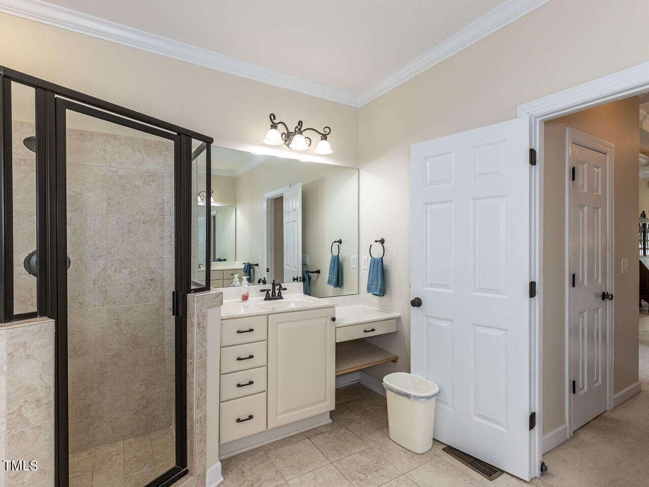 119 Oldefield Lane Garner, NC 27529 - Photo 18 of 38 a spacious bathroom with a double vanity sink a mirror and a shower