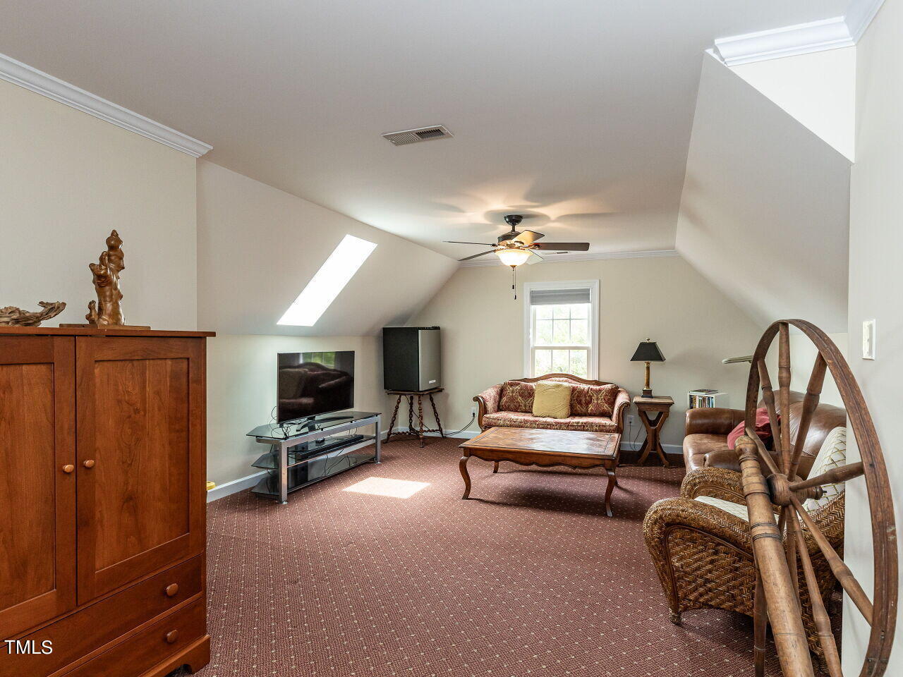 119 Oldefield Lane Garner, NC 27529 - Photo 26 of 38 a living room with furniture a flat screen tv and a window