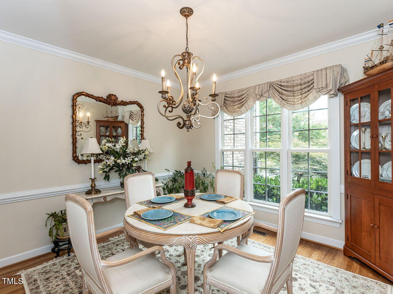 119 Oldefield Lane Garner, NC 27529 - Photo 5 of 38 a dining room with furniture a large window and wooden floor