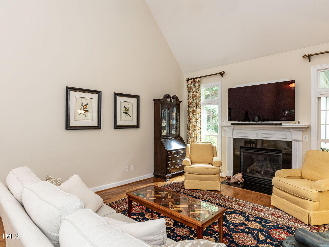 119 Oldefield Lane Garner, NC 27529 - Photo 7 of 38 a living room with furniture a flat screen tv and a fireplace
