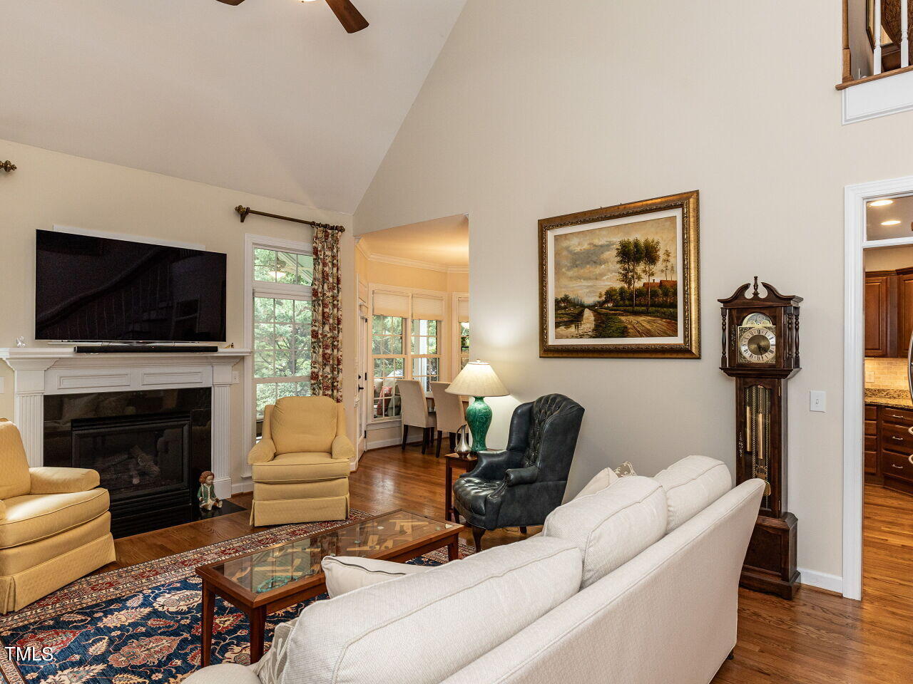 119 Oldefield Lane Garner, NC 27529 - Photo 8 of 38 a living room with furniture a flat screen tv and a fireplace