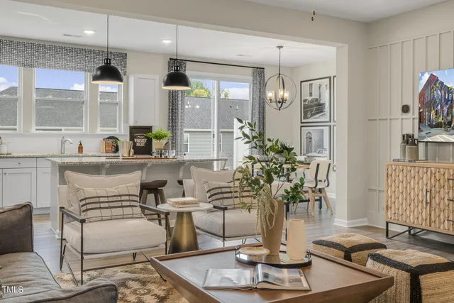 a living room with furniture and a chandelier