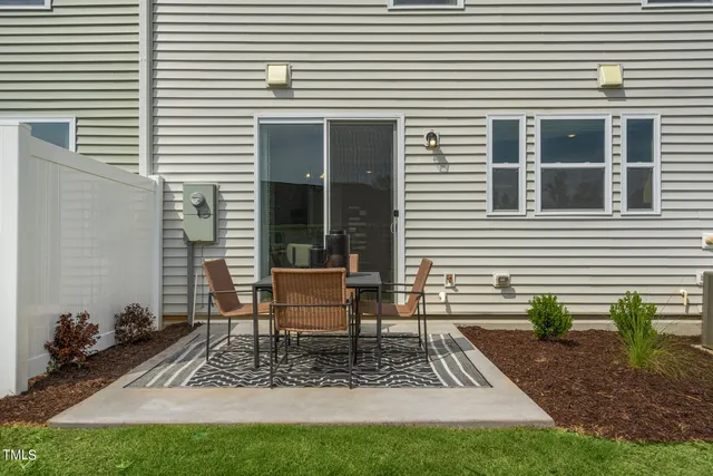 a view of a patio with couches table and chairs and potted plants