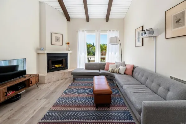 a living room with furniture a rug and a fireplace