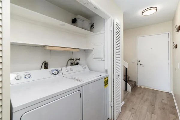 a view of a hallway with wooden floor and entryway