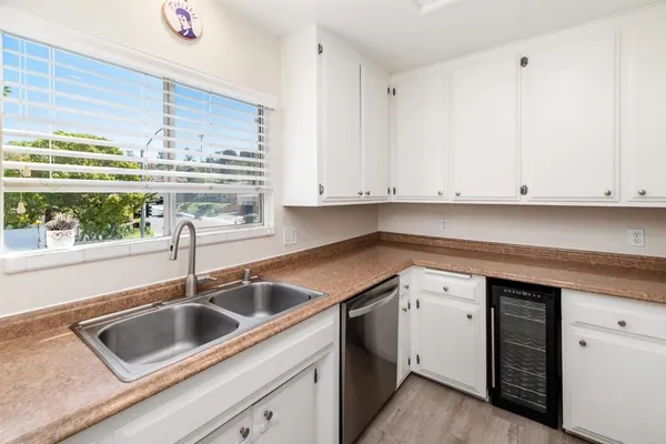 a kitchen with a sink cabinets and window