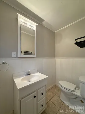 a bathroom with a sink a toilet and mirror