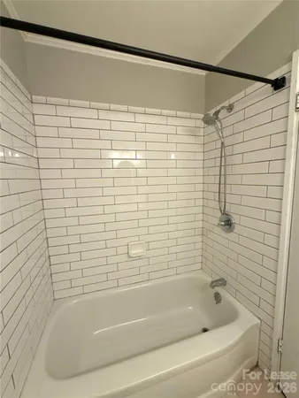 a bathroom with a shower and a bathtub