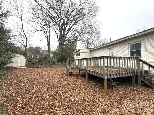 a view of a backyard with a deck and a garden