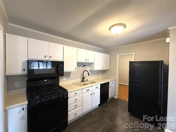 a kitchen with a refrigerator stove and sink