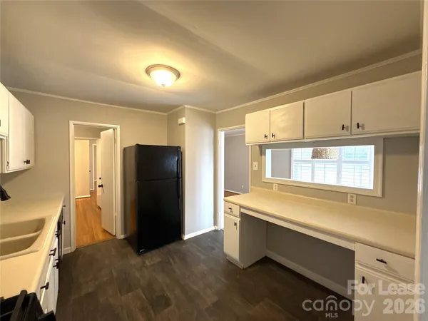 a kitchen with a refrigerator and window