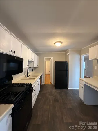 a large kitchen with a stove and a refrigerator