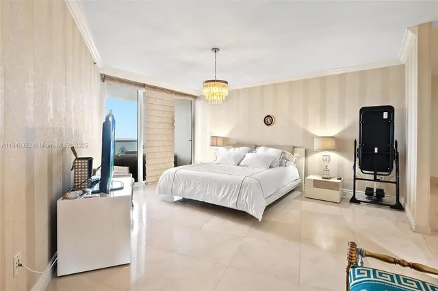 a bedroom with a bed and a chandelier