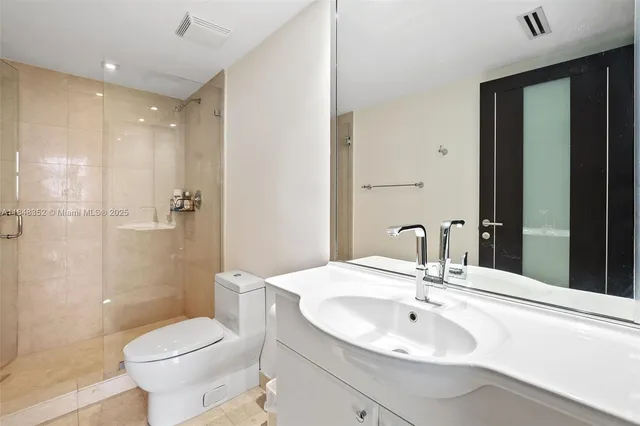 a bathroom with a tub a double vanity sink and mirror