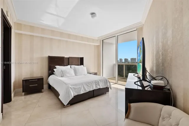 a bedroom with a bed and a flat screen tv