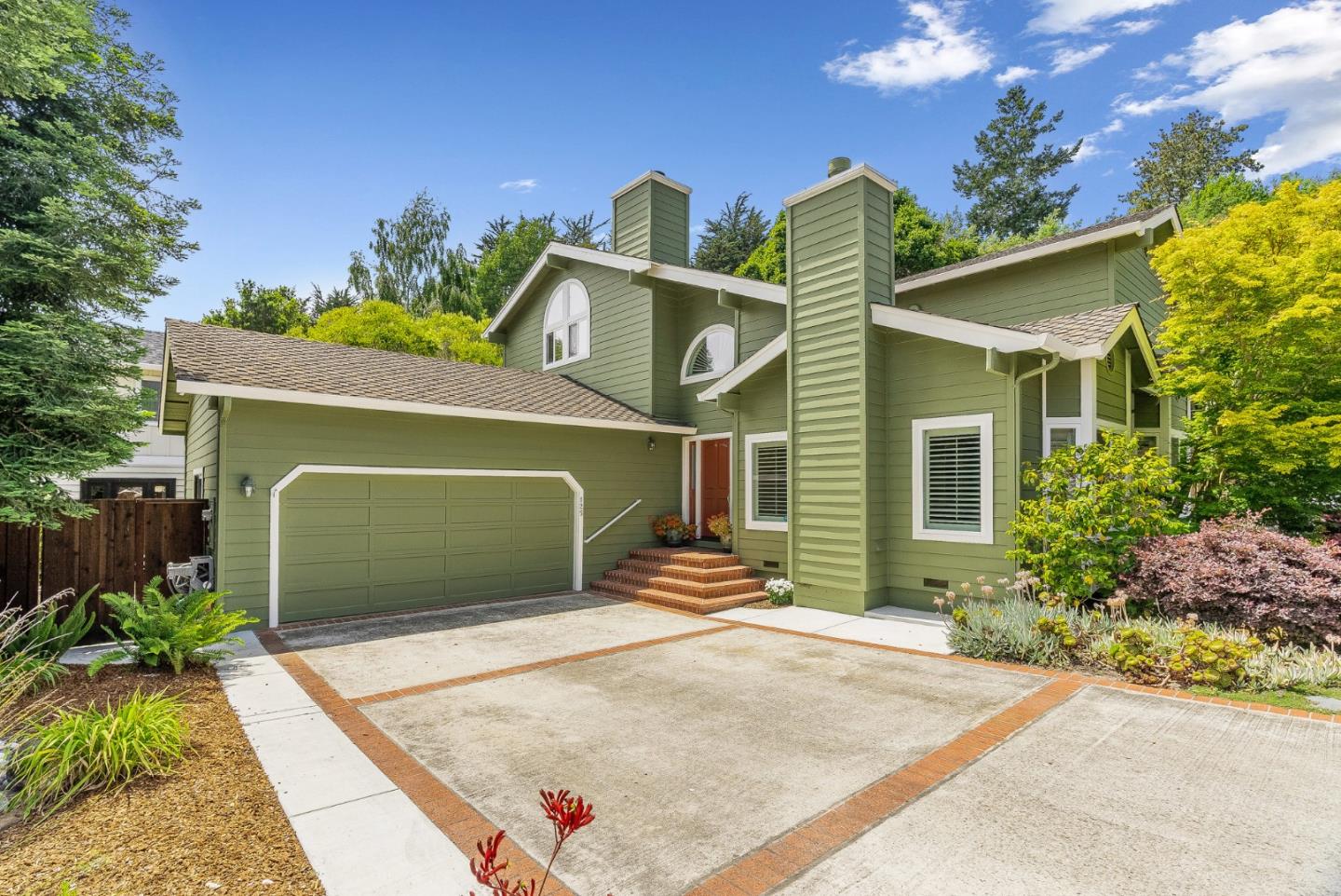 a front view of a house with garden