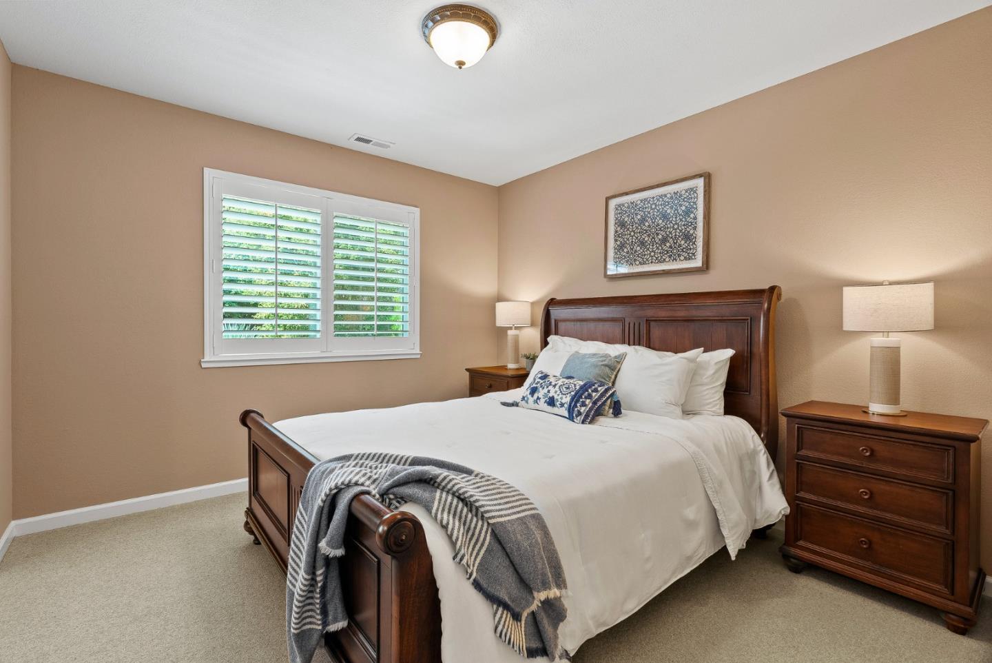 125 Chase Lane Aptos, CA 95003 - Photo 17 of 34 a bedroom with a bed and a lamp on dresser