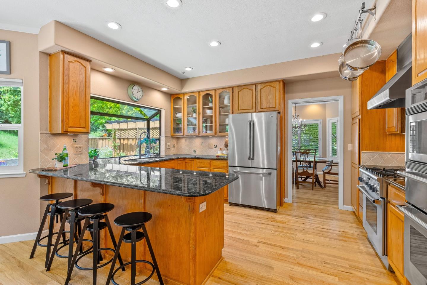 125 Chase Lane Aptos, CA 95003 - Photo 5 of 34 a kitchen with stainless steel appliances granite countertop refrigerator stove top oven dining table and chairs