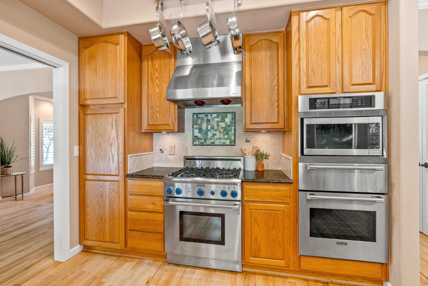 125 Chase Lane Aptos, CA 95003 - Photo 6 of 34 a kitchen with stainless steel appliances granite countertop a stove and a microwave