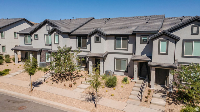 1693 Devils Gdn Lane Washington, UT 84780 - Photo 1 of 64 Modern townhome facade featuring stucco and stone accents