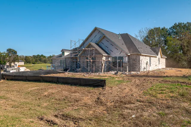 a view of a house with swimming pool and sitting area