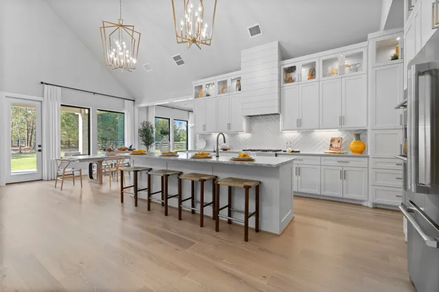 a kitchen with a table chairs stove and cabinets