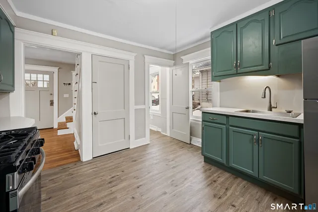a kitchen with granite countertop wooden cabinets and a sink