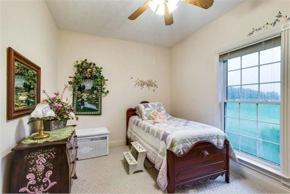 7768 Webster Road White House, TN 37188 - Photo 23 of 30 a bedroom with a bed and a chandelier