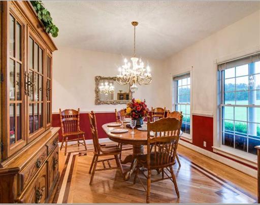 7768 Webster Road White House, TN 37188 - Photo 8 of 30 a view of a dining room with furniture a chandelier and wooden floor