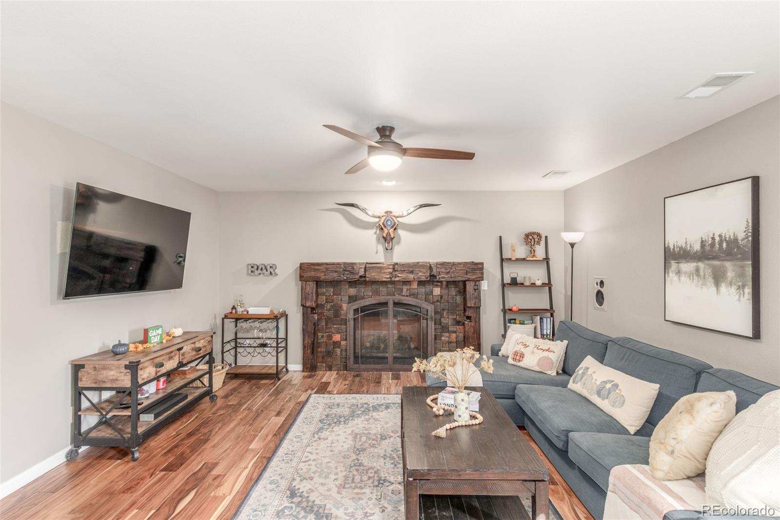 4864 Parsons Way Castle Rock, CO 80104 - Photo 11 of 50 a living room with furniture a fireplace and a flat screen tv