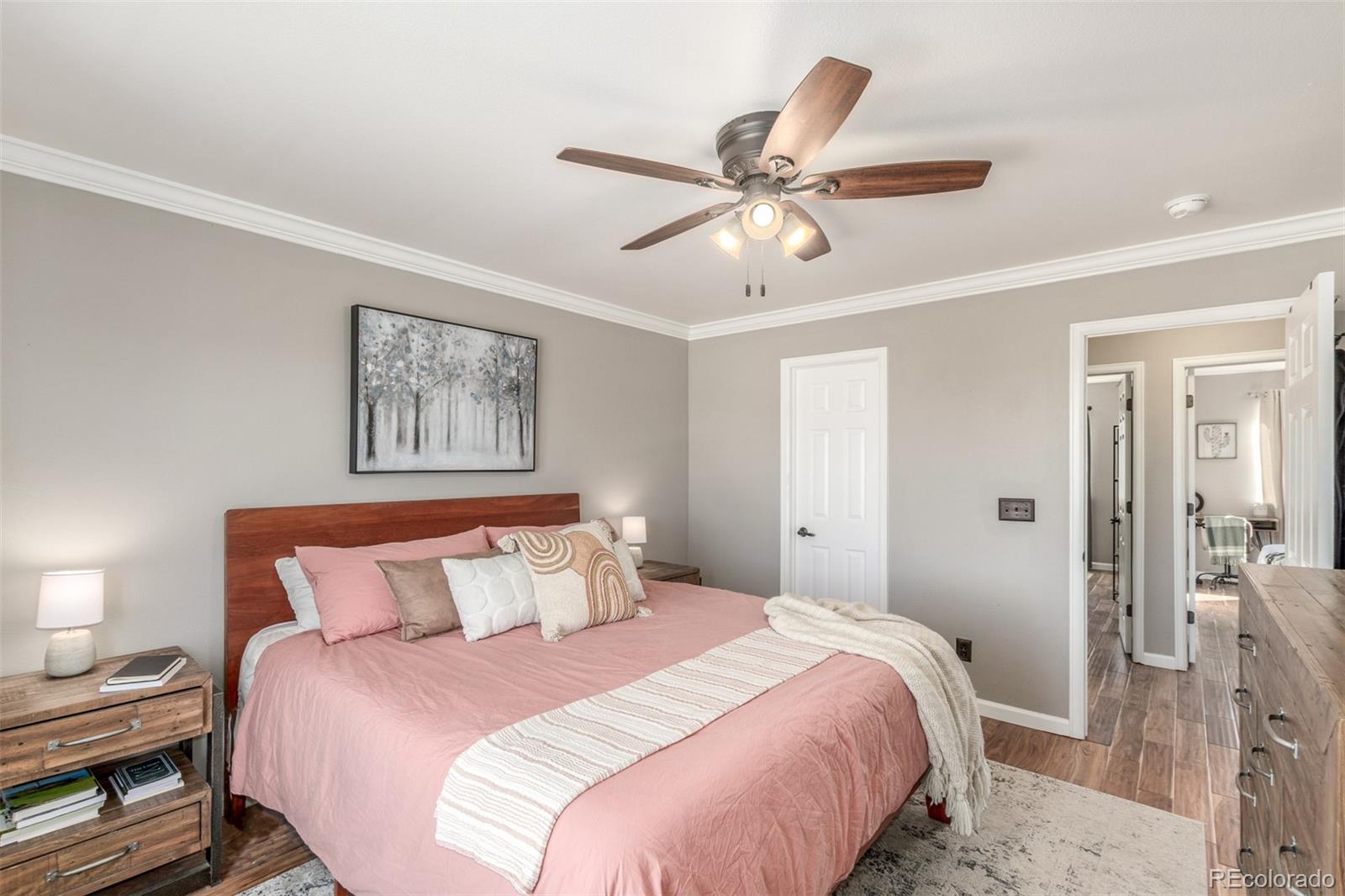 4864 Parsons Way Castle Rock, CO 80104 - Photo 14 of 50 a bedroom with a bed and a chandelier