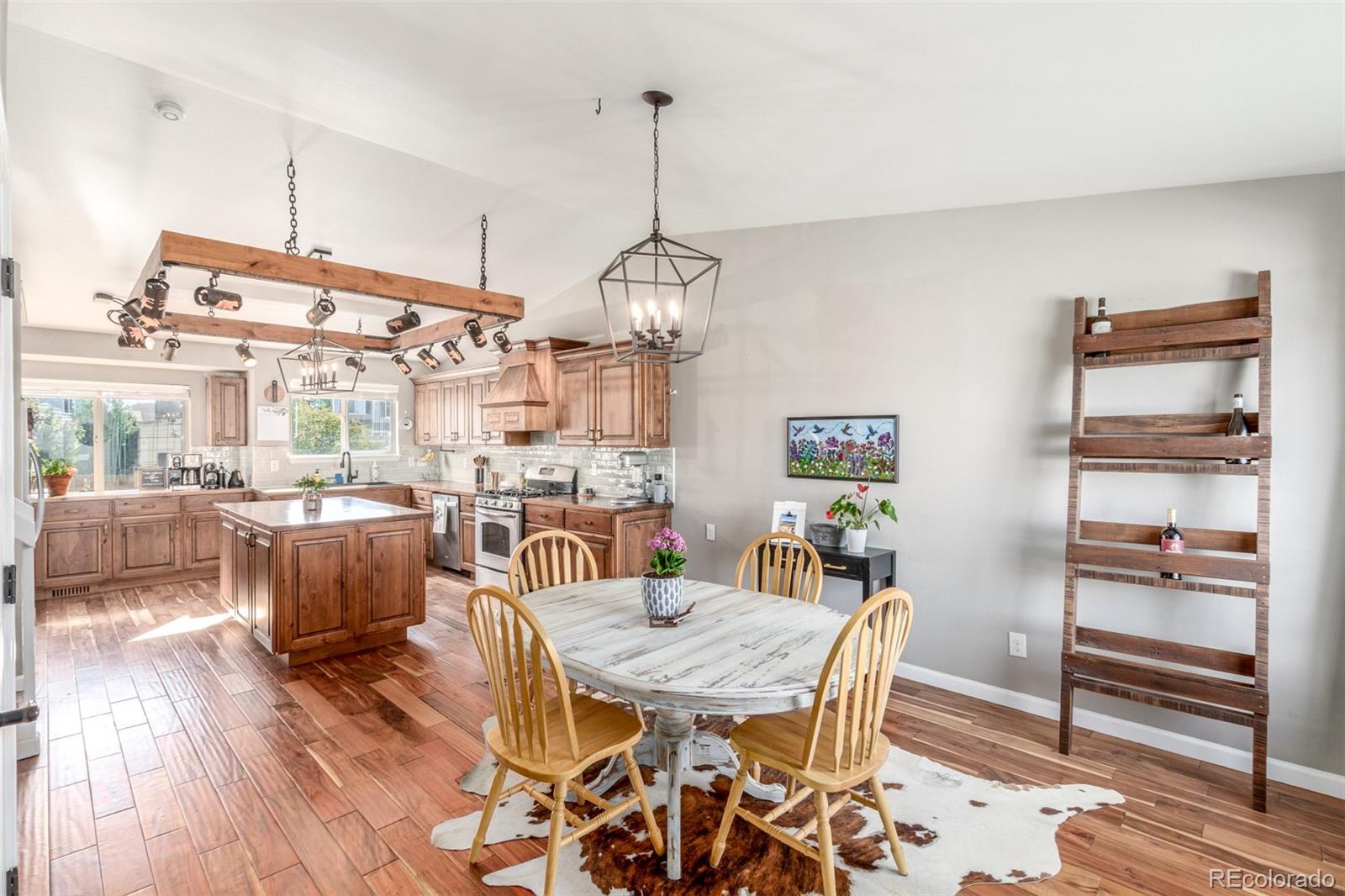 4864 Parsons Way Castle Rock, CO 80104 - Photo 2 of 50 a dining room with furniture a chandelier and wooden floor