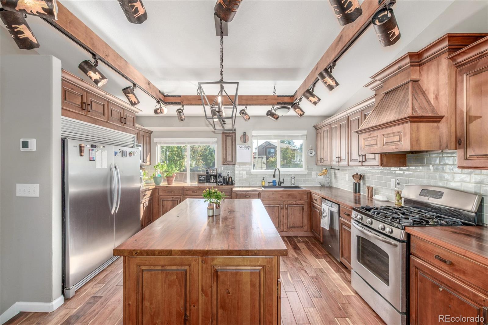 4864 Parsons Way Castle Rock, CO 80104 - Photo 3 of 50 a kitchen with stainless steel appliances granite countertop a sink a stove and a refrigerator