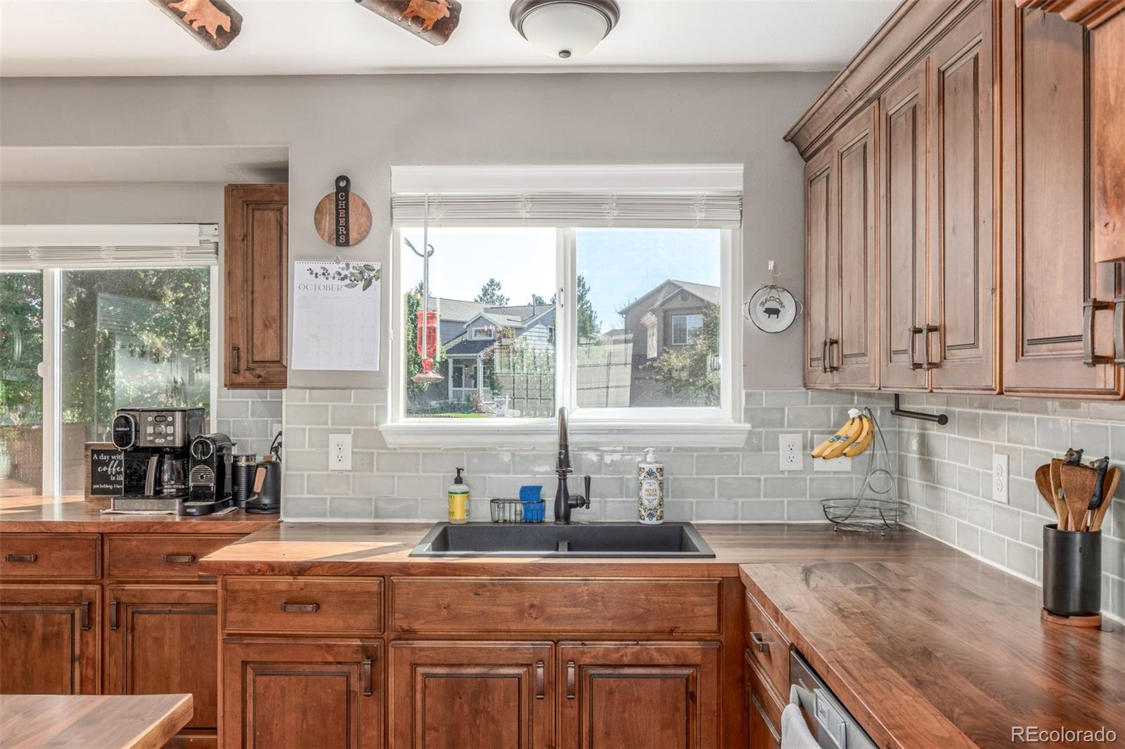 4864 Parsons Way Castle Rock, CO 80104 - Photo 4 of 50 a kitchen with stainless steel appliances wooden cabinets a sink a stove and a window