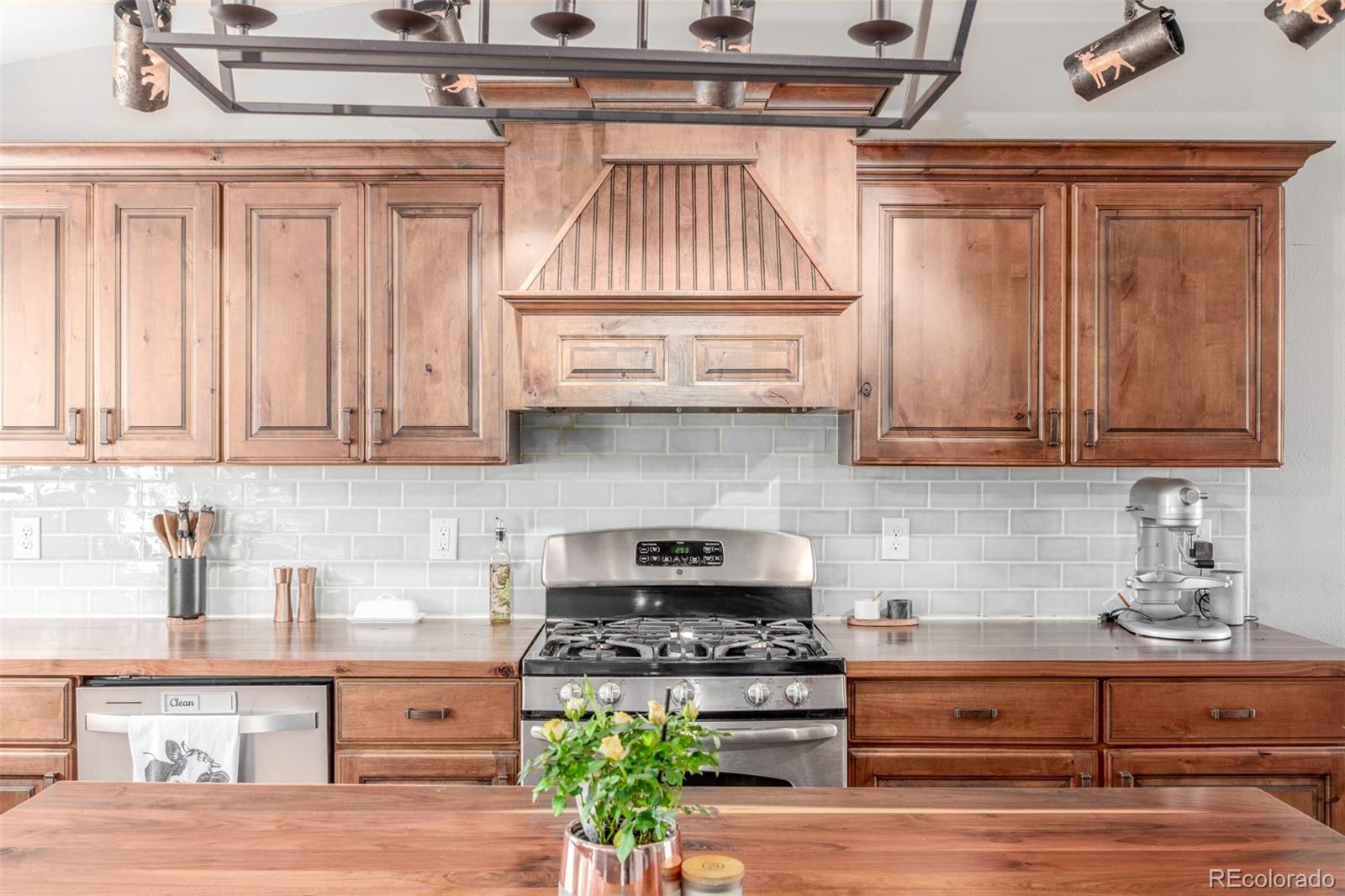 4864 Parsons Way Castle Rock, CO 80104 - Photo 5 of 50 a kitchen with stainless steel appliances granite countertop a stove a sink and a microwave