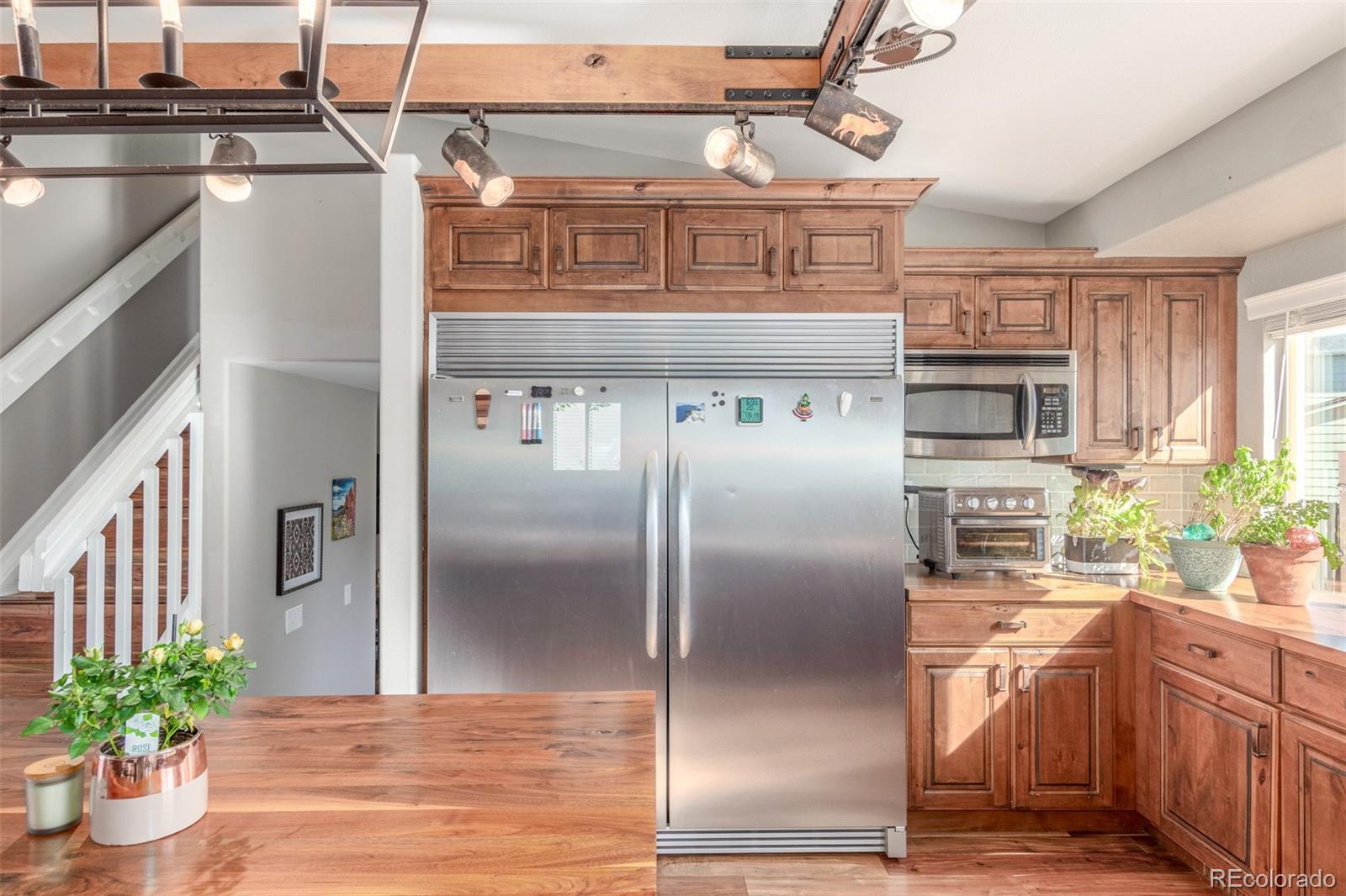 4864 Parsons Way Castle Rock, CO 80104 - Photo 6 of 50 a kitchen with stainless steel appliances granite countertop a refrigerator a stove and a sink