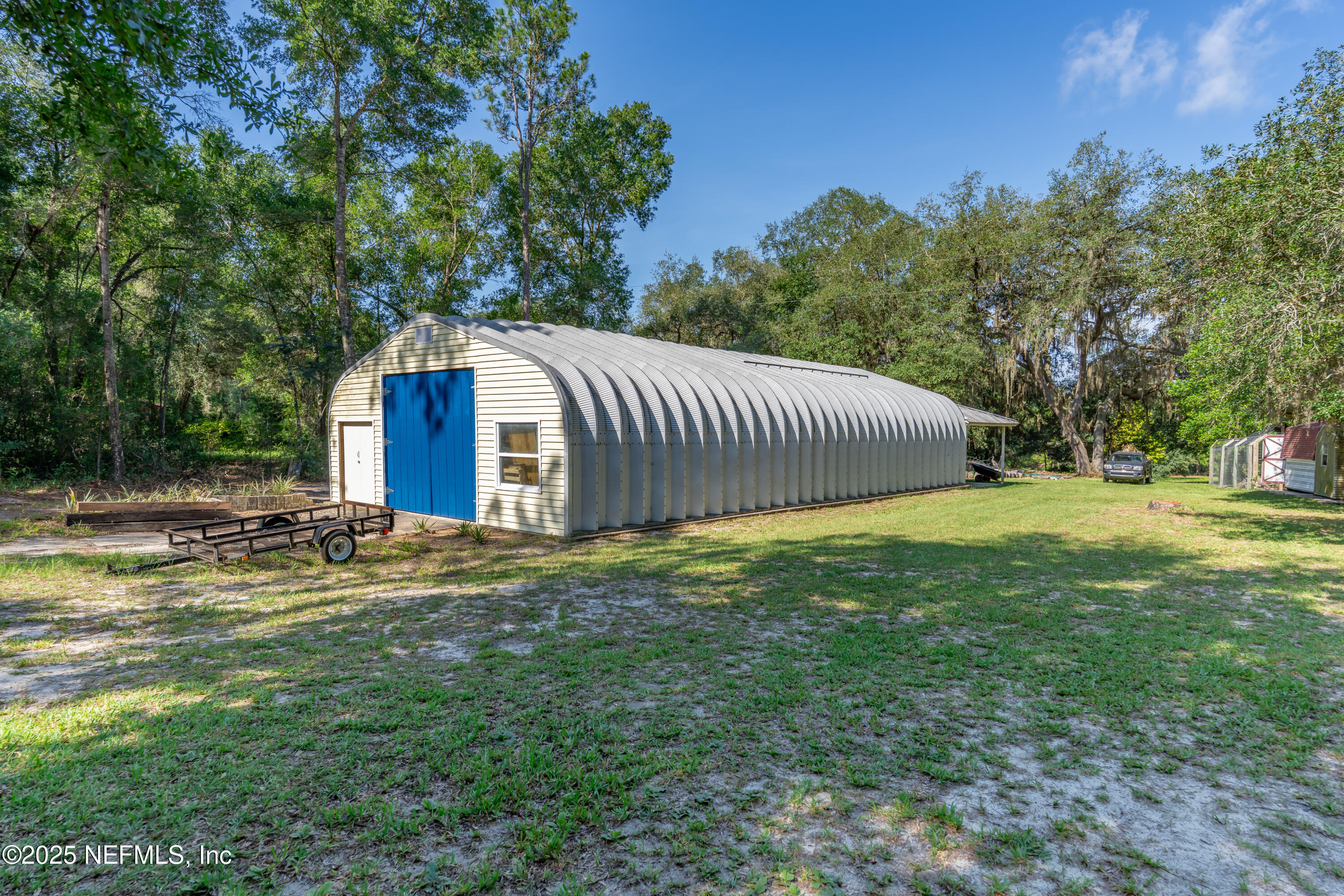 8048 County Line Road Melrose, FL 32666 - Photo 12 of 40 a view of a backyard with a garden