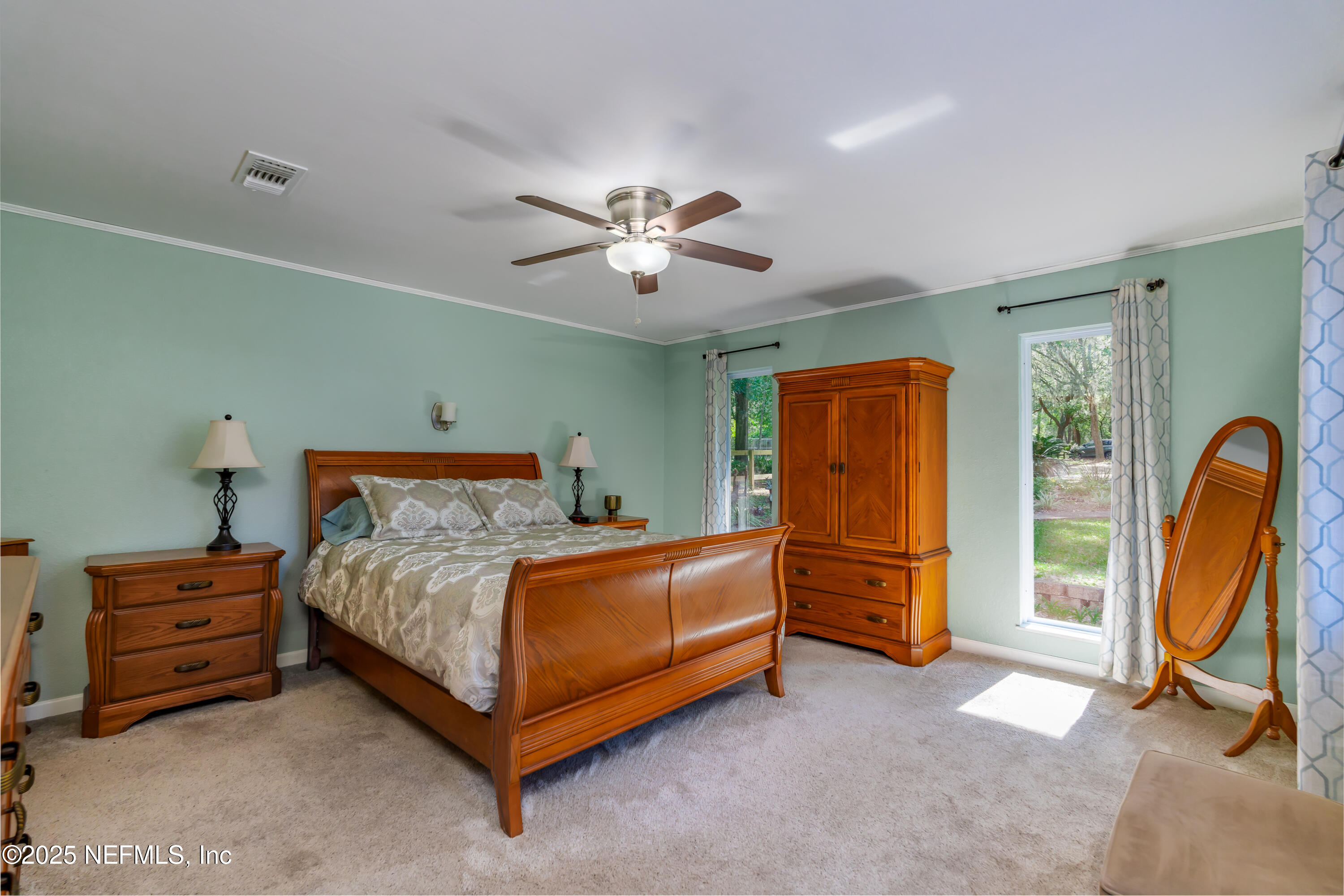8048 County Line Road Melrose, FL 32666 - Photo 17 of 40 a bedroom with a bed and a chandelier
