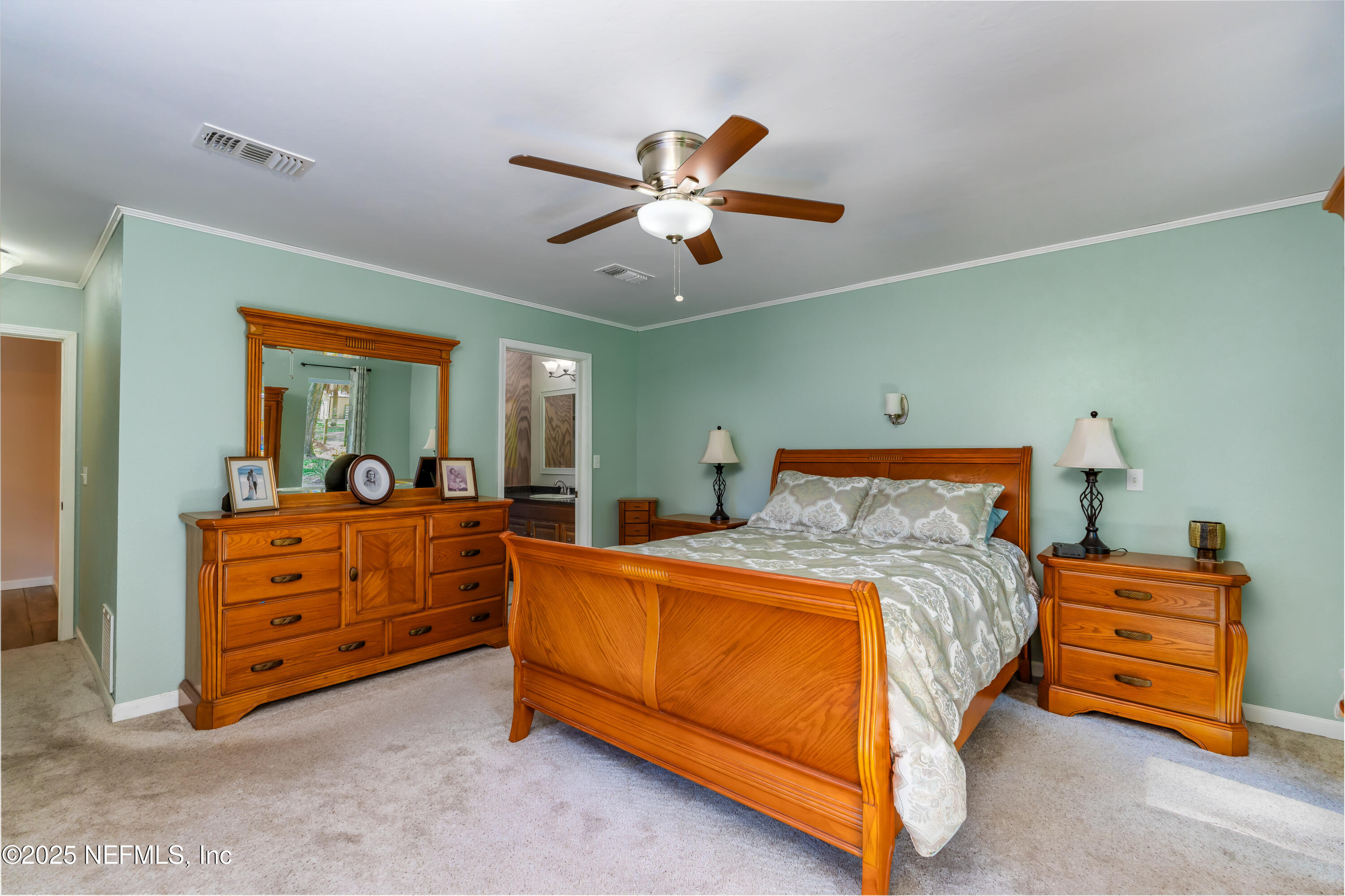8048 County Line Road Melrose, FL 32666 - Photo 18 of 40 a bed room with a bed and a chandelier