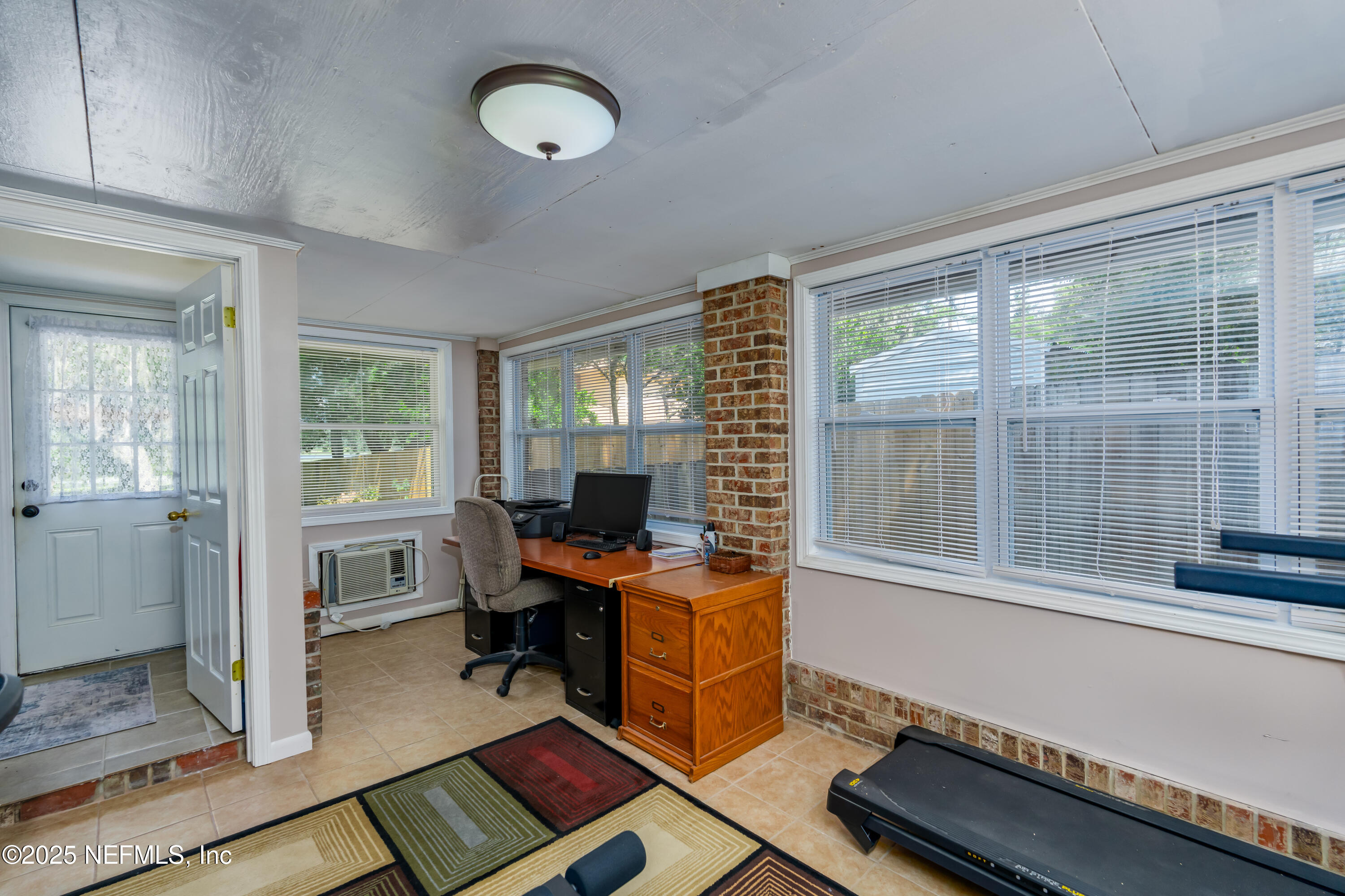 8048 County Line Road Melrose, FL 32666 - Photo 32 of 40 a view of a workspace with furniture and a window
